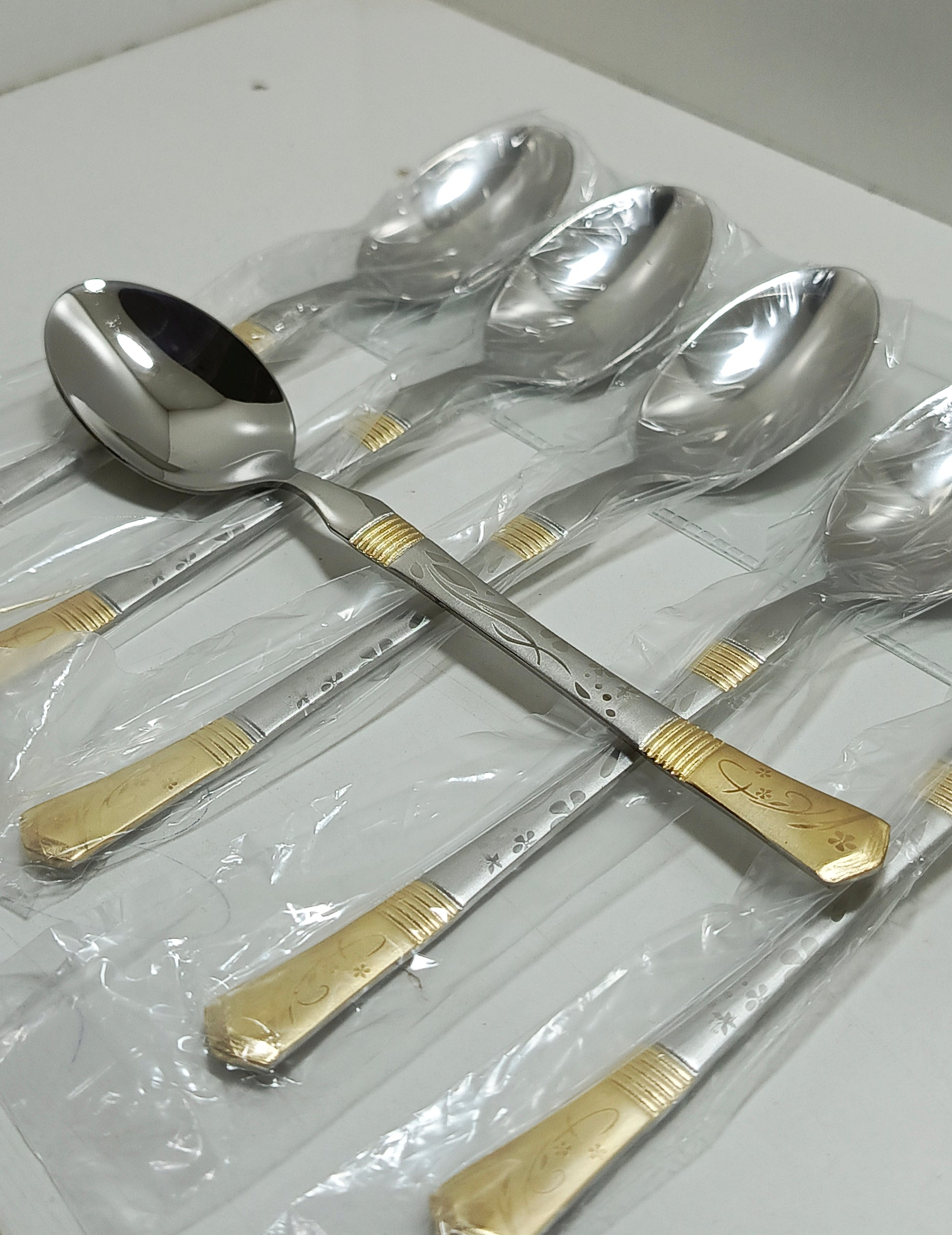 Set of silver spoons with gold accents 